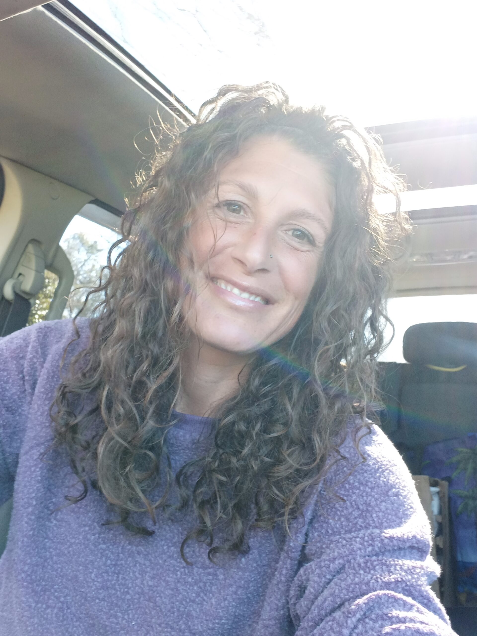 Charlene In a purple top in a car 